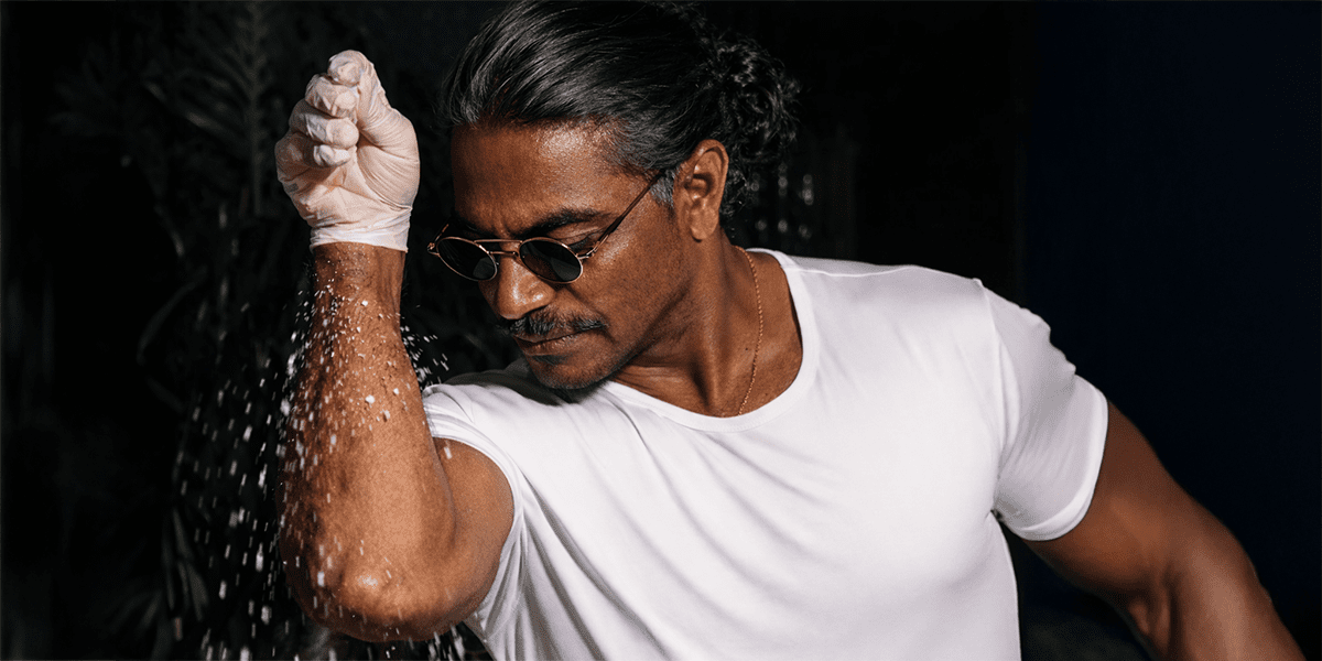 Man sprinkling salt with concept image representing high sodium intake and its effects on heart and blood vessel health