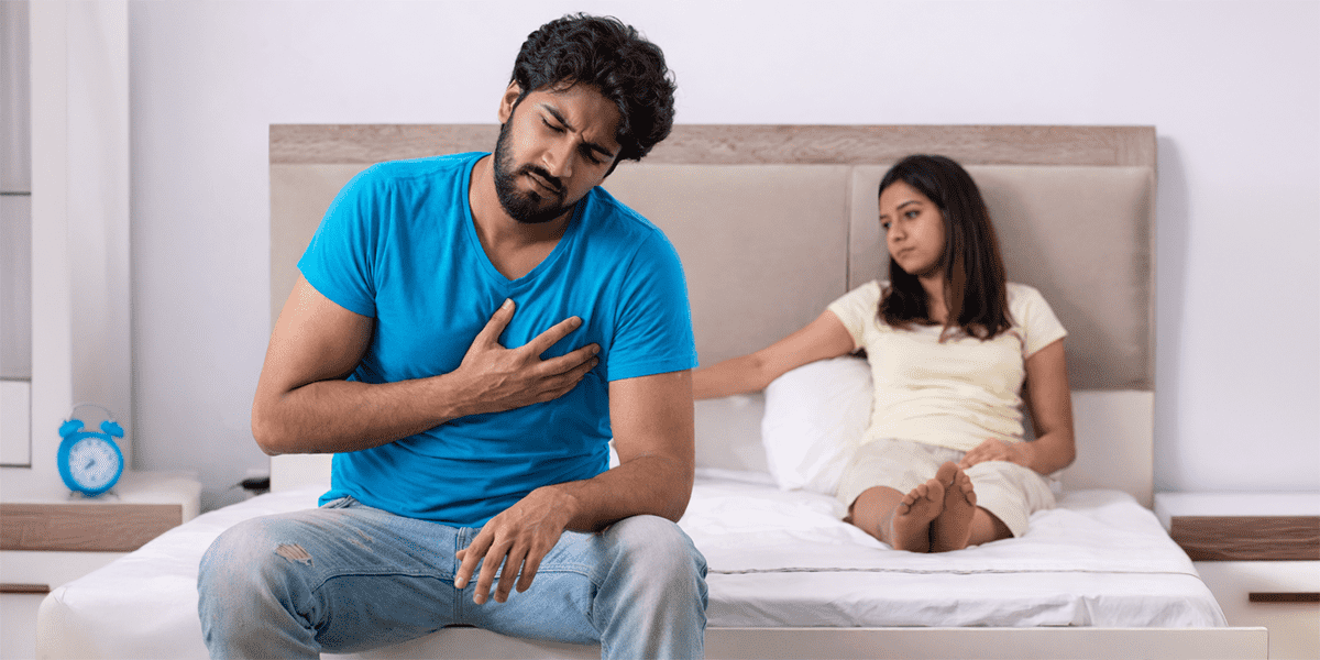 Couple experiencing fertility concerns sitting on bed representing infertility and reproductive health challenges