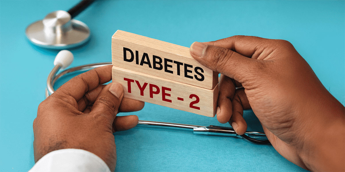 Hands holding blocks labeled Type 2 Diabetes with stethoscope representing metabolic disorder and diabetes diagnosis
