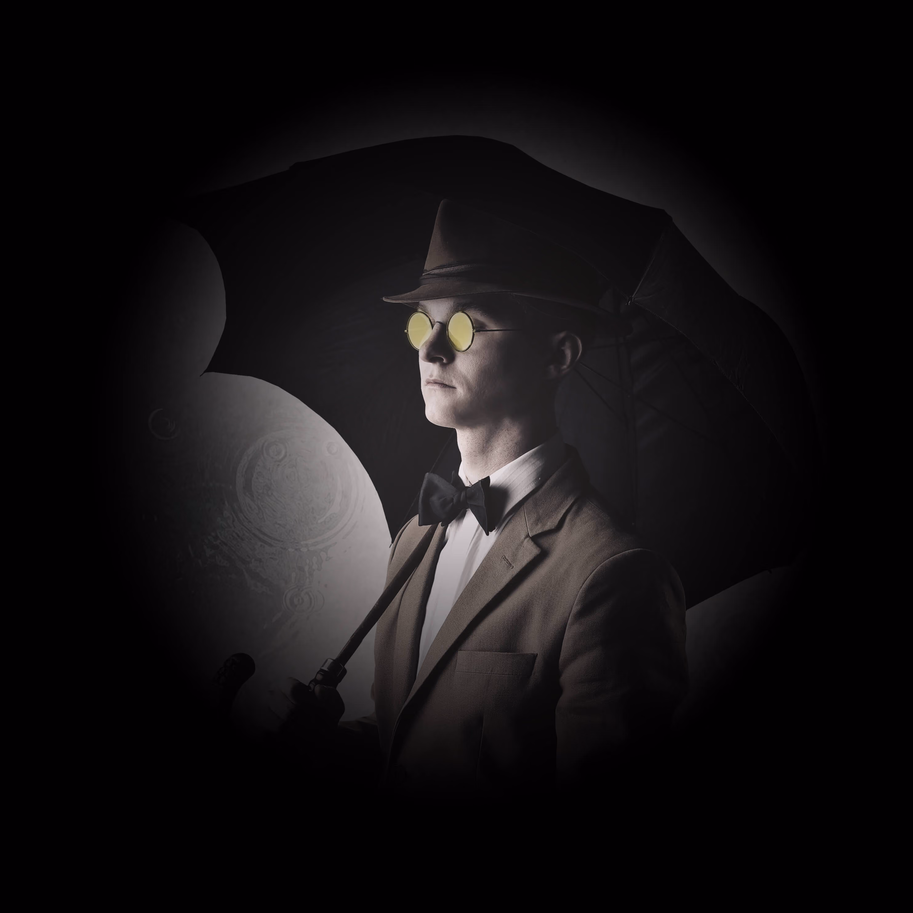 A well dressed man holding an umbrella