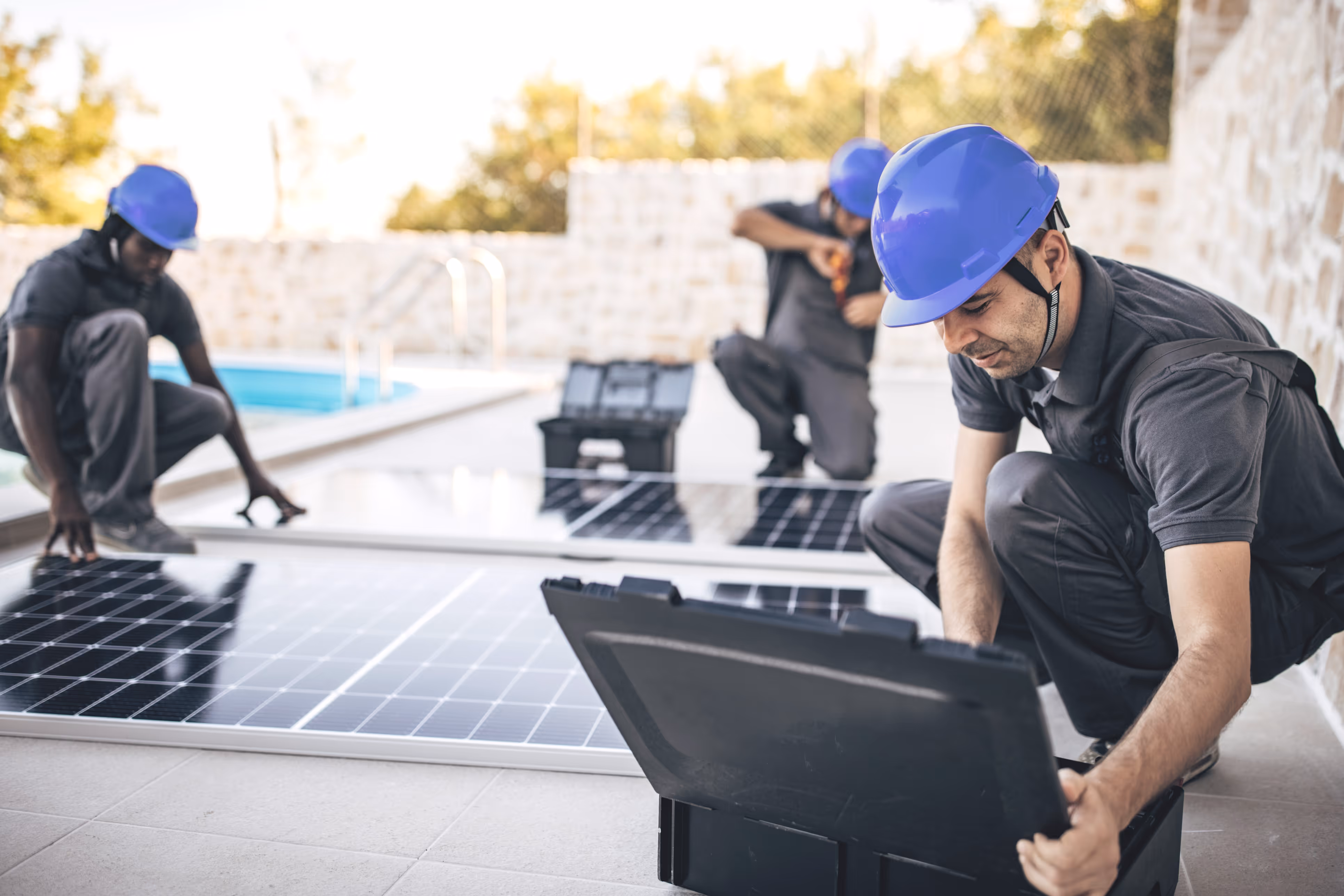 A group of men working on a solar panel.