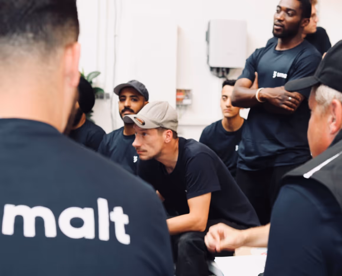 A group of men sitting around each other.
