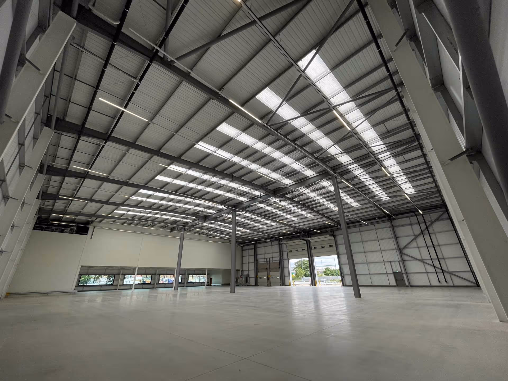 A large, empty warehouse interior with a high ceiling and open space.