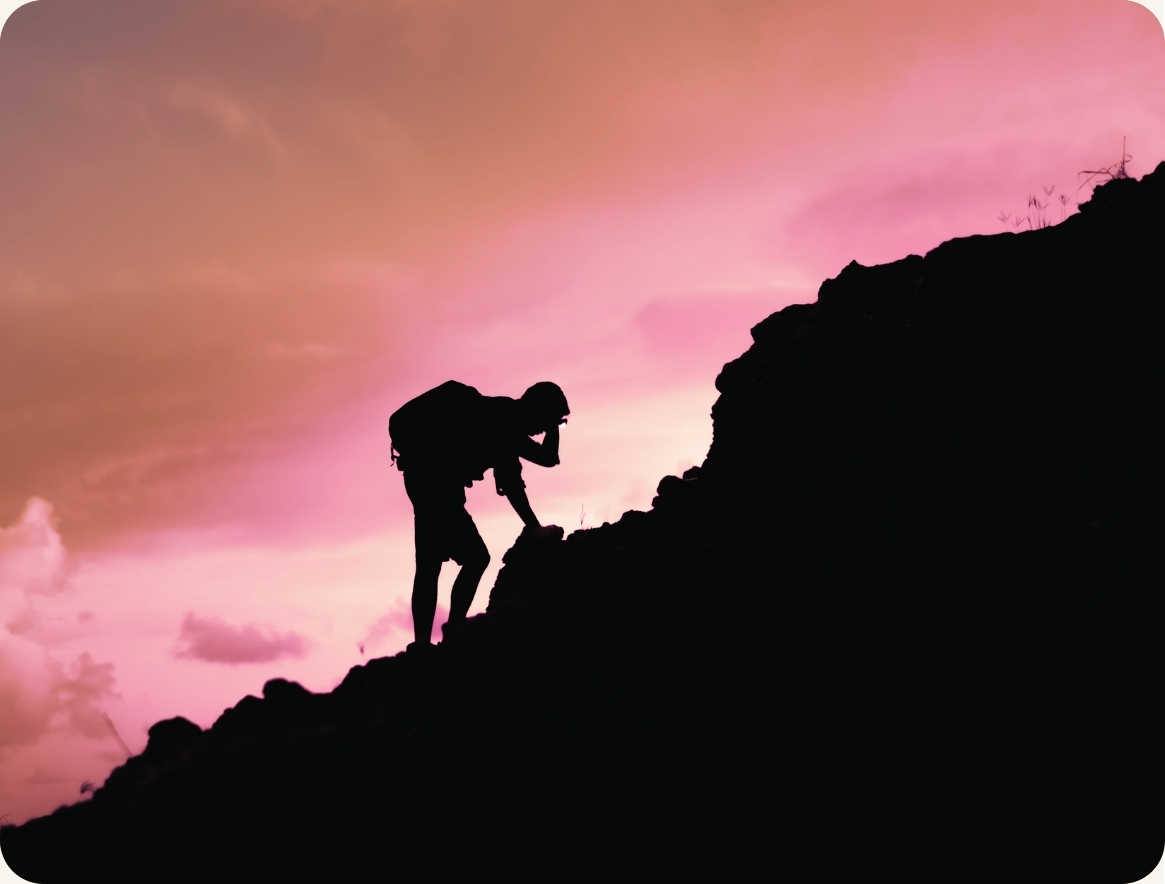 A climber ascending a mountain, representing the journey from senior leader to the summit of an executive career