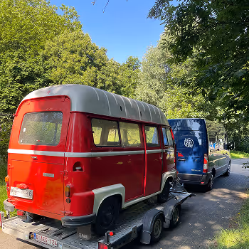 Burger with fried fries on black plate with sauce on the side