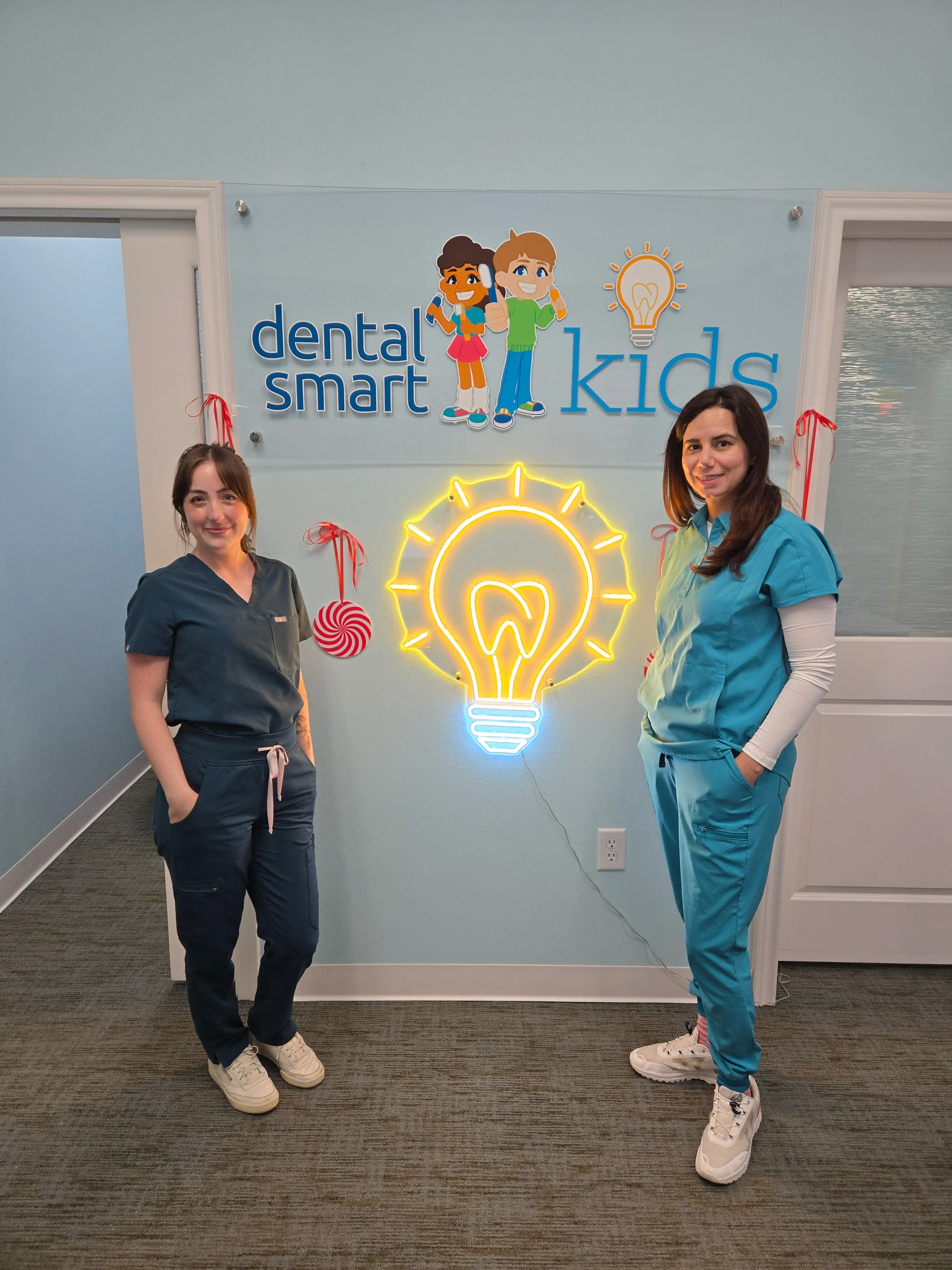 a diverse, modern nurse smiling warmly as they comfort a child patient
