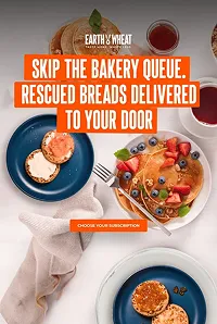 Flat lay of a breakfast scene with pancakes topped with fruit and syrup, two plates with toasted bread, a hand holding a fork, and text reading 'Skip the bakery queue. Rescued breads delivered to your door' from Earth & Wheat.
