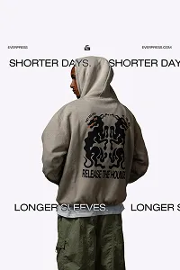 Person wearing a gray hooded sweatshirt with a large black graphic and text 'RELEASE THE POWER' on the back.