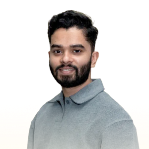Smiling man with short dark hair and beard wearing a light gray collared shirt.