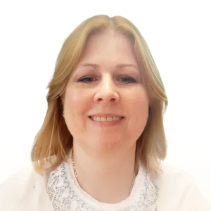 Smiling woman with shoulder-length blonde hair wearing a white top with lace detail.