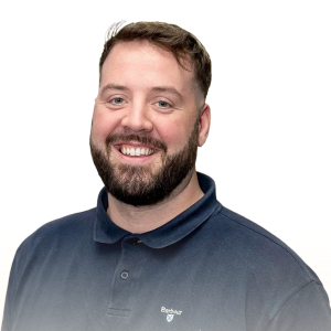 Smiling man with beard and short hair wearing a navy blue polo shirt.