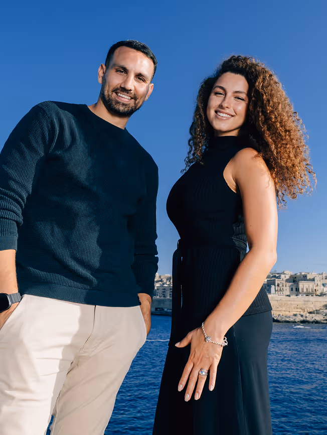 A man and woman smiling and posing at the camera.
