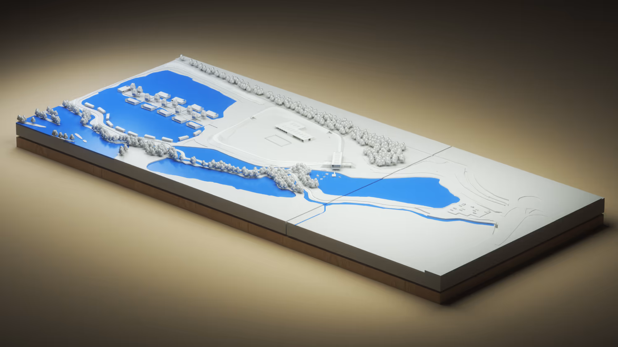Architectural scale model featuring blue water bodies, white buildings, roads, and clusters of trees.