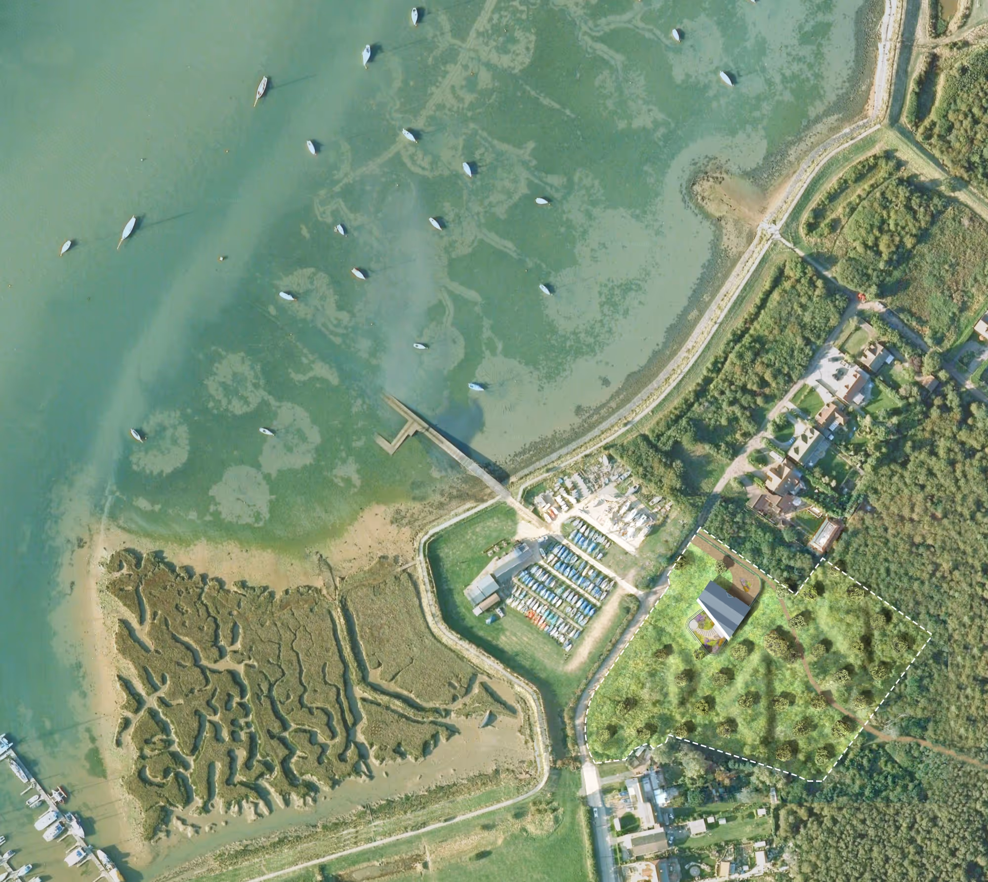 Aerial view of a coastal area with boats moored offshore, a pier, a marina with boats on land, and a green landscape with scattered trees and houses.