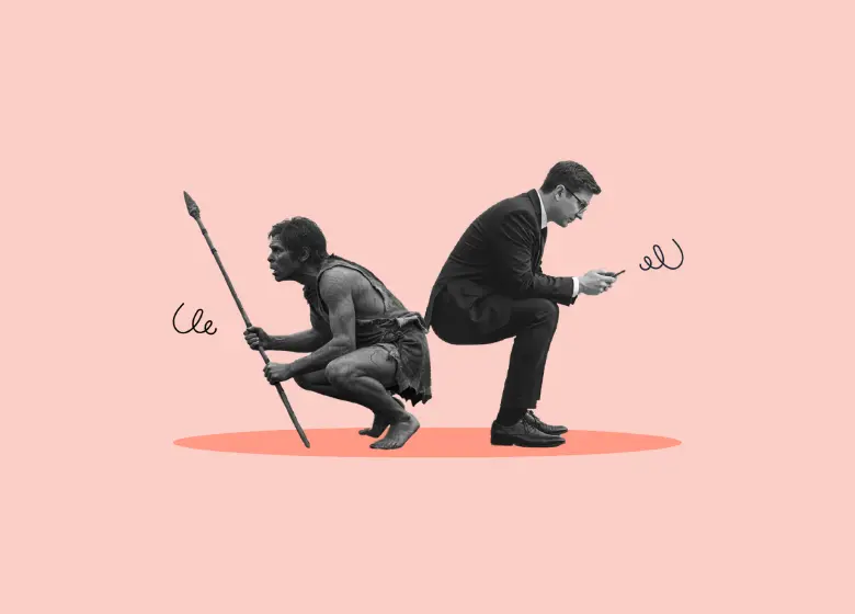 A caveman and a man in a suit on his smartphone sit back-to-back to illustrate our ancient nervous system’s mismatch with our modern environment