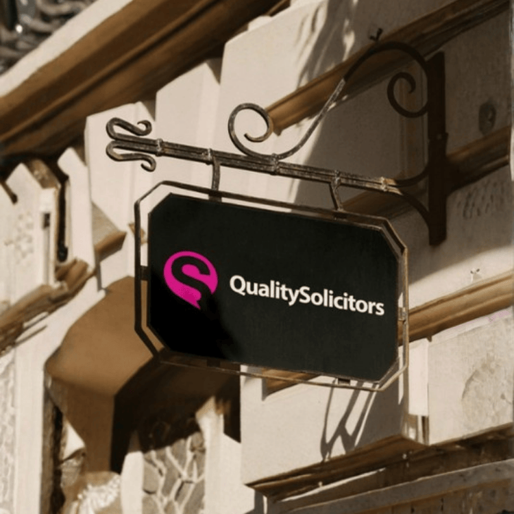 Retail shop sign mockup demonstrating brand identity and physical touchpoints for QualitySolicitors
