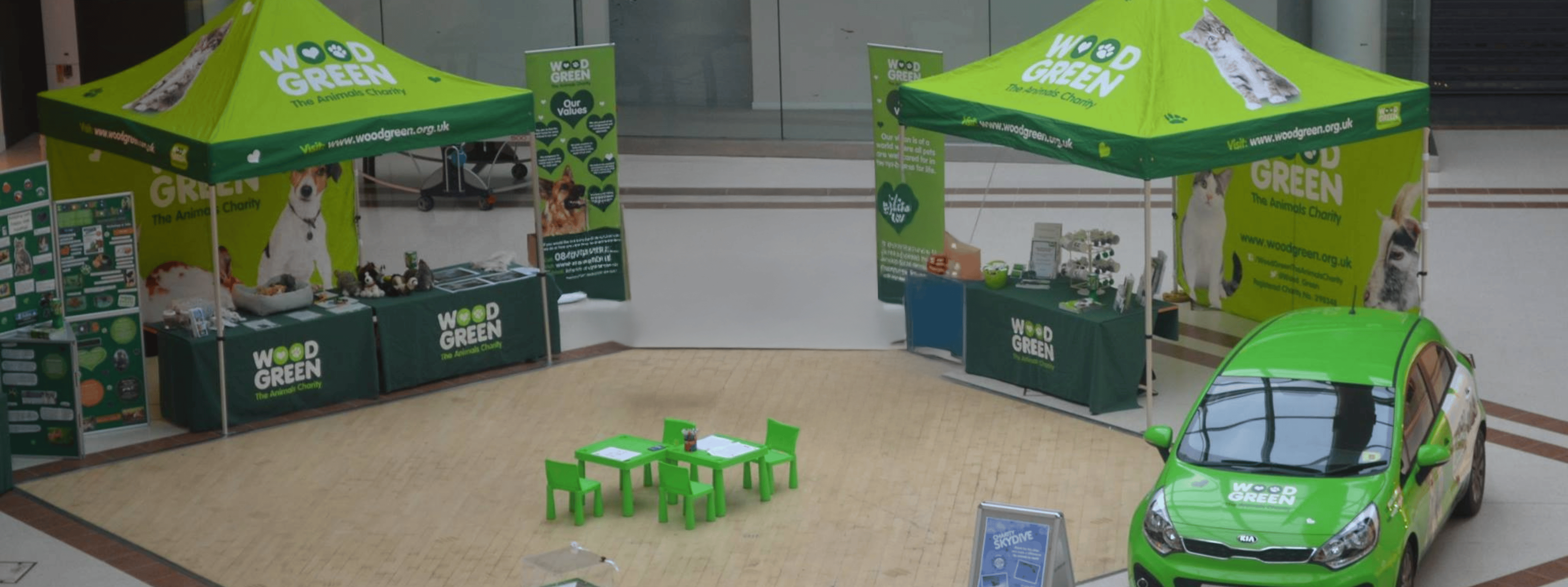 Wood Green charity Christmas campaign stand engaging local community with donation opportunities.