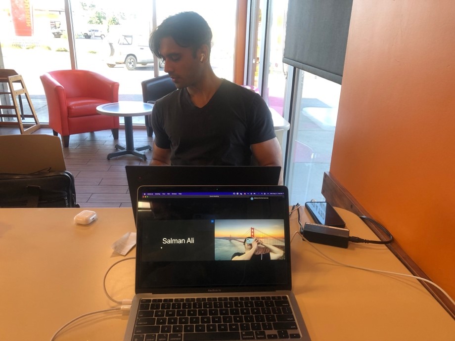 A person sitting at a table with a computerDescription automatically generated with medium confidence