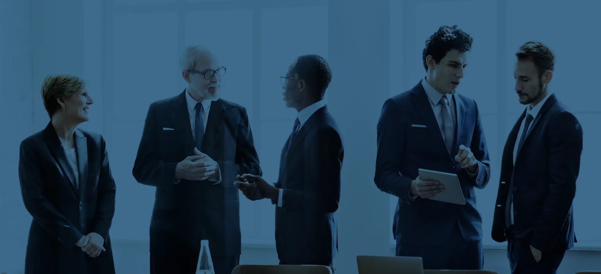 team of business executives speaking with one another