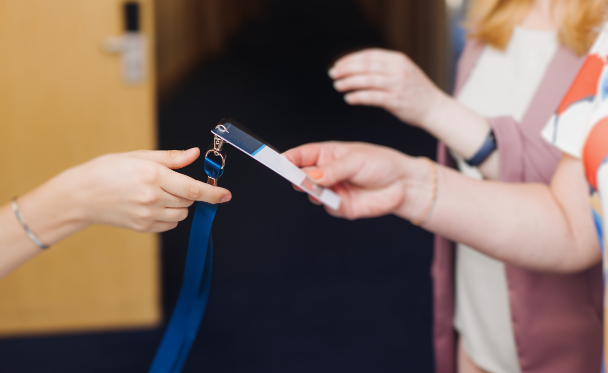 person taking a badge during event check in
