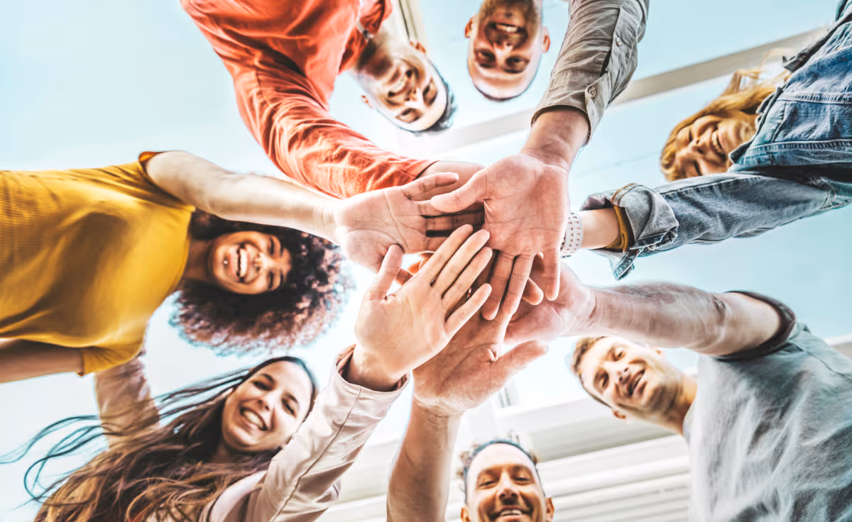 community of people stacking hands