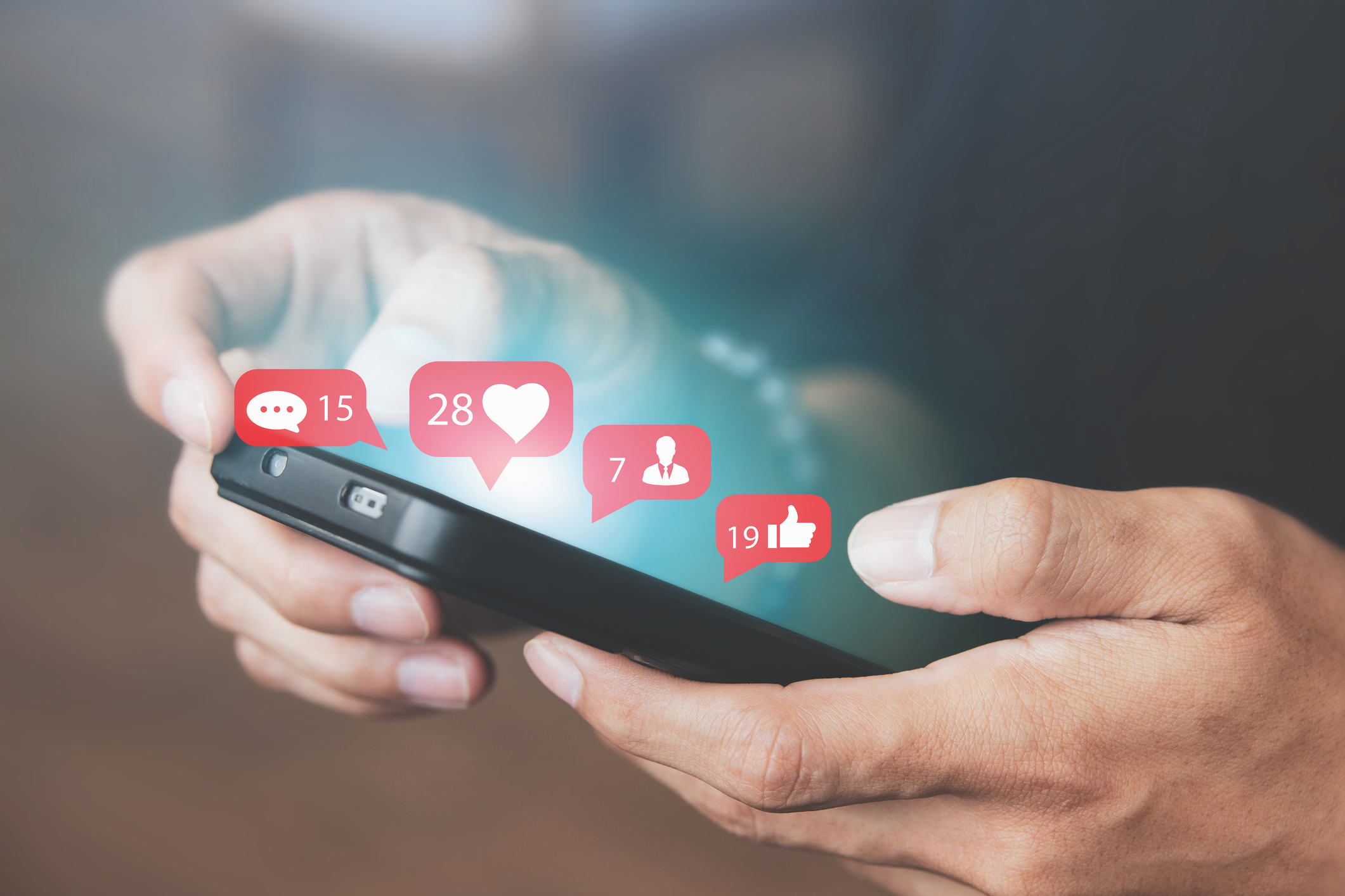 closeup of phone with icons for liking and connecting