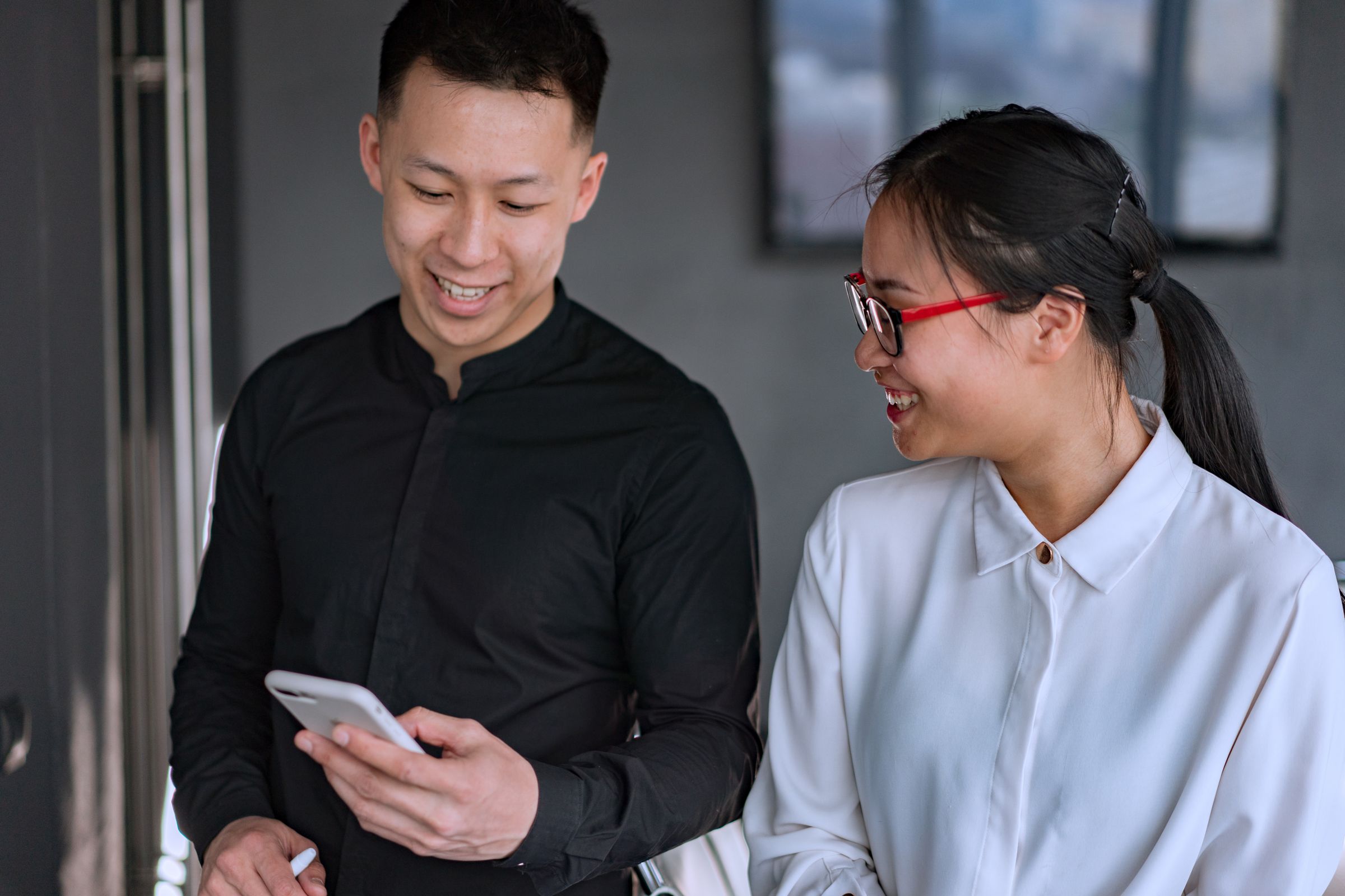 Two people looking at a phone together
