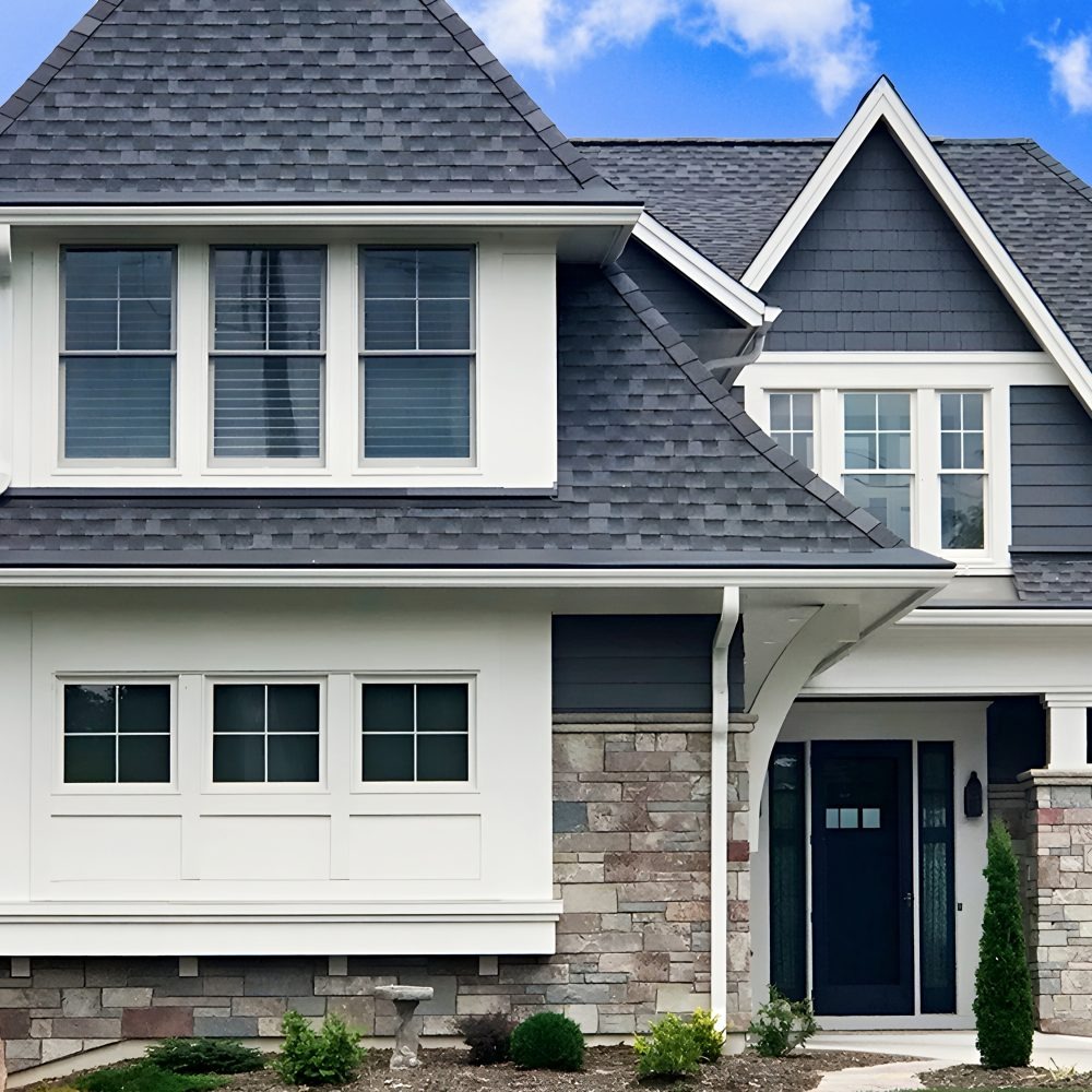 Modern two-story house with white, gray, and stone exterior