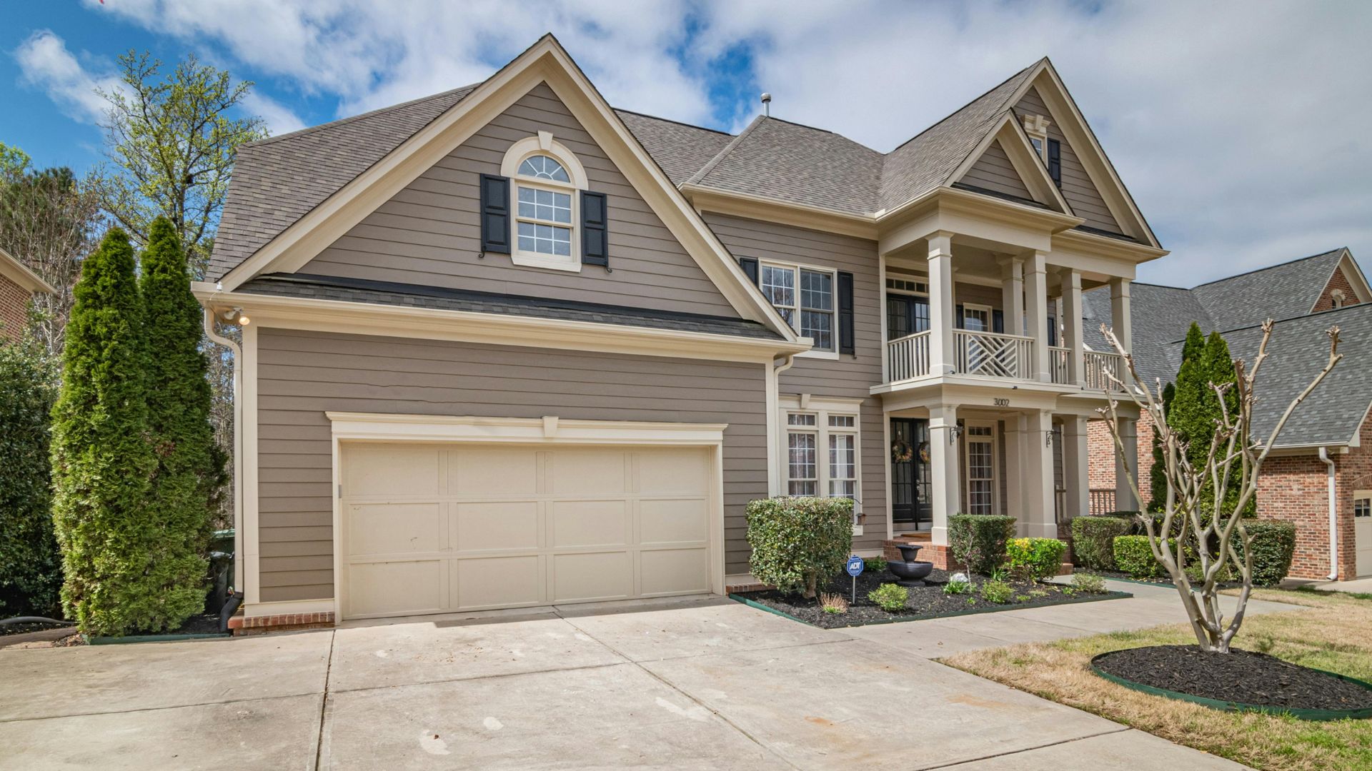 Two-story suburban house with two-car garage and landscaped front yard