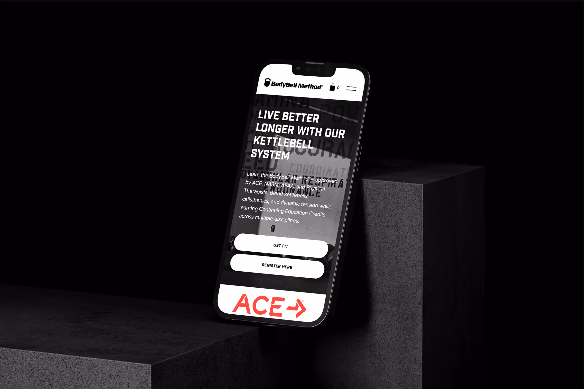 Smartphone displaying the BodyBell Method website promoting kettlebell fitness with options to get fit or register, against a dark background.