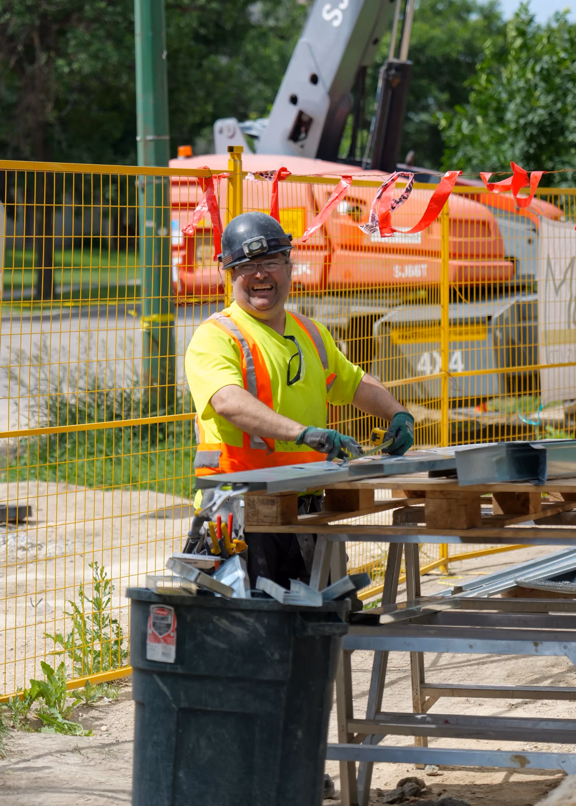 Dupont Interiors worker cutting steel studs at the jobsite bench