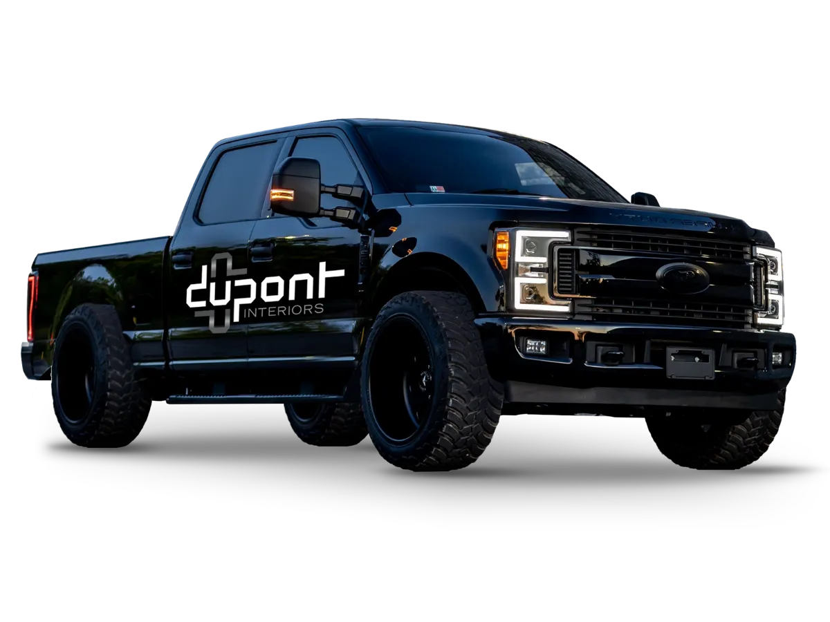 Black Dupont Interiors pickup truck with company branding on the door
