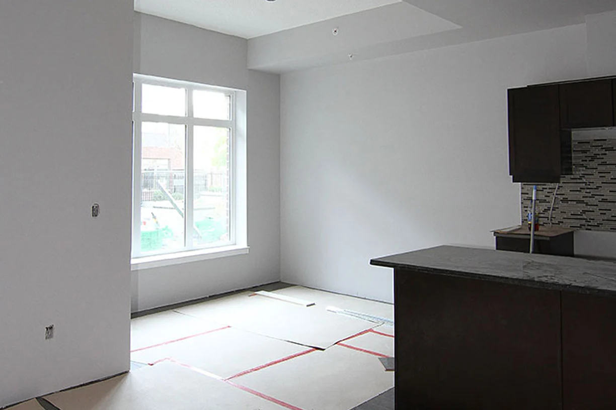 New Winnipeg apartment suite with finished drywall, kitchen island and protected flooring