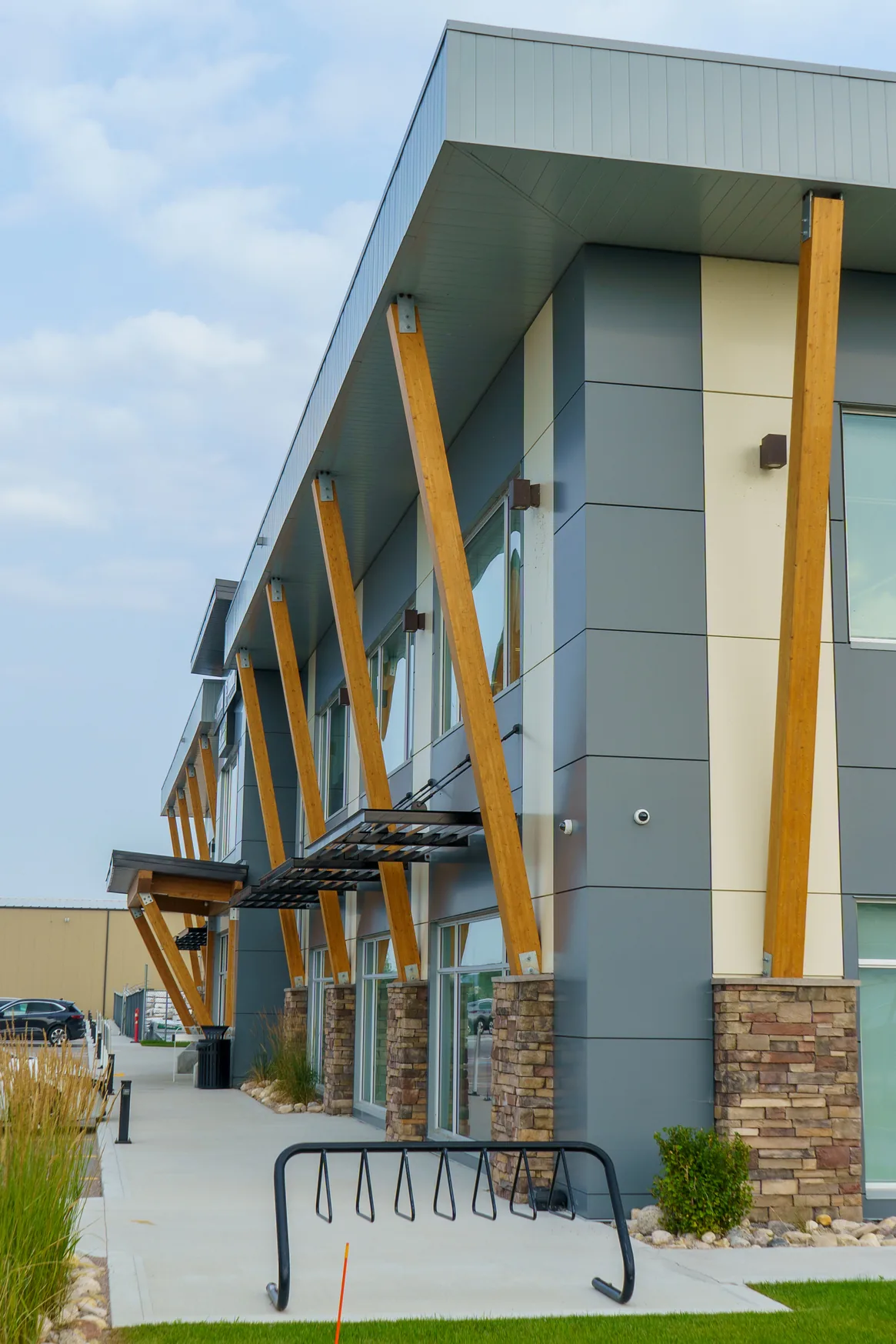 Timber columns and stone-clad entrance at 570 Rue Camiel Sys Street in Winnipeg