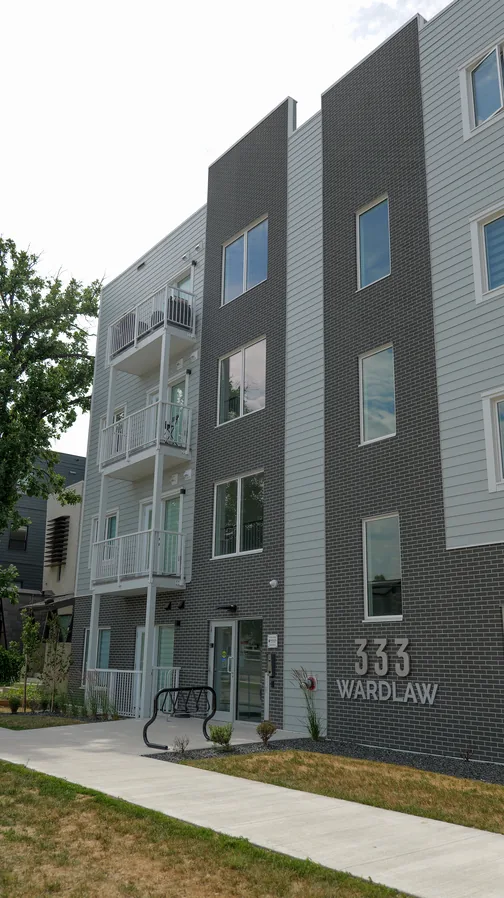 Entrance to 333 Wardlaw in Winnipeg with the building name on the brick base
