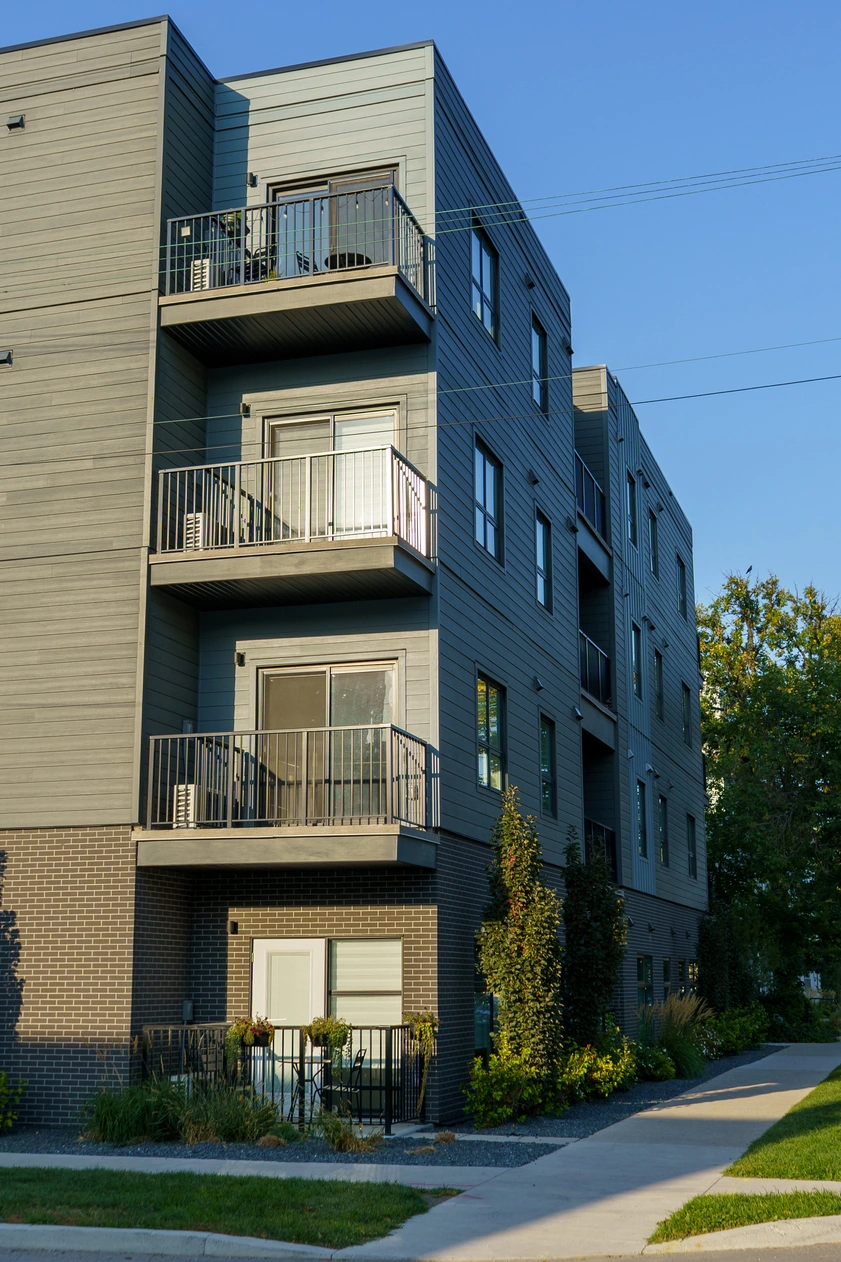 Front elevation of 162 Scott Street in Winnipeg with balconies over a brick base