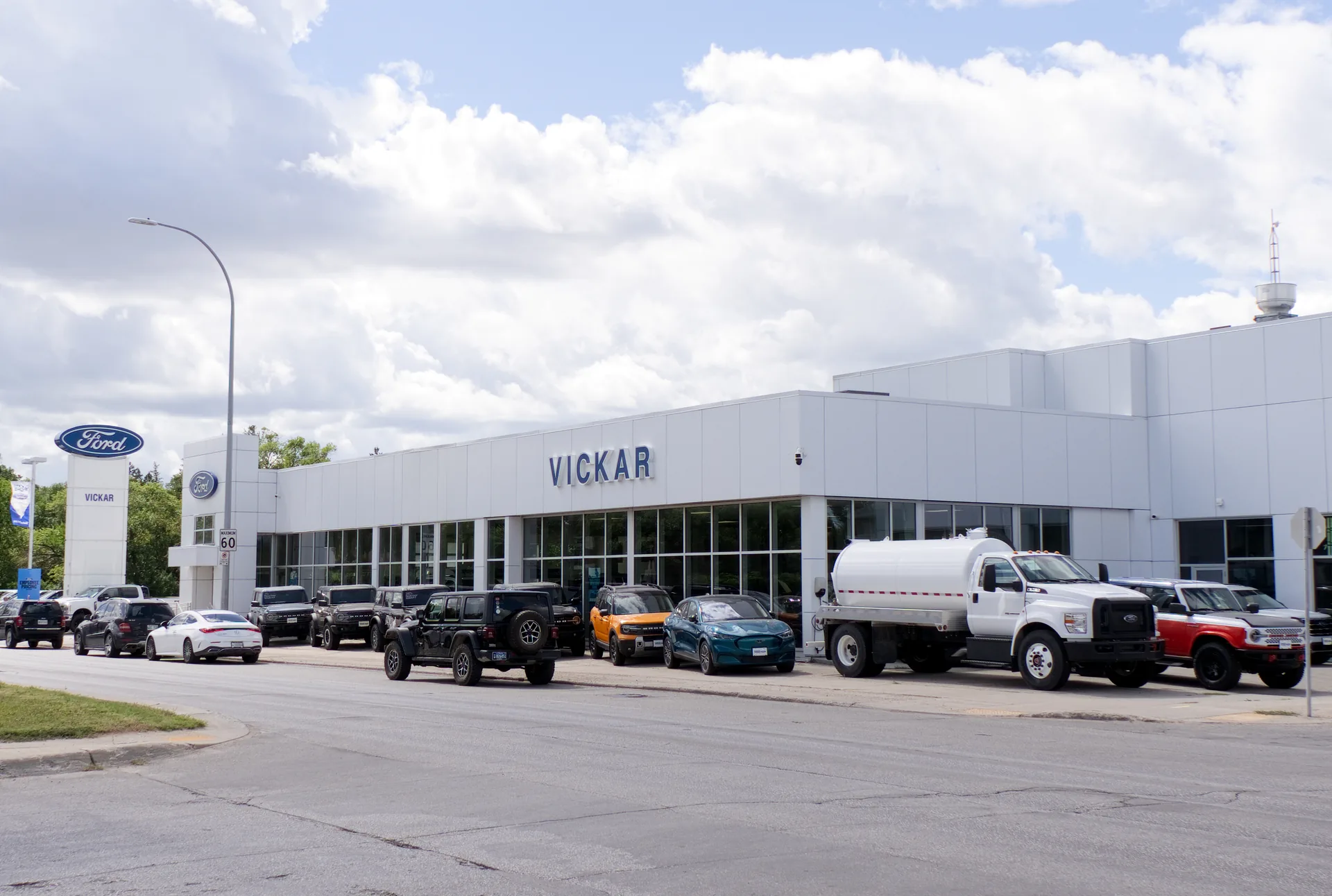 Vickar Parkside Ford dealership in Winnipeg seen from the street, showroom glazing and service centre behind
