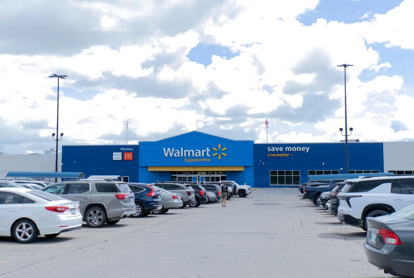 Walmart Supercentre storefront in Winnipeg seen across the parking lot