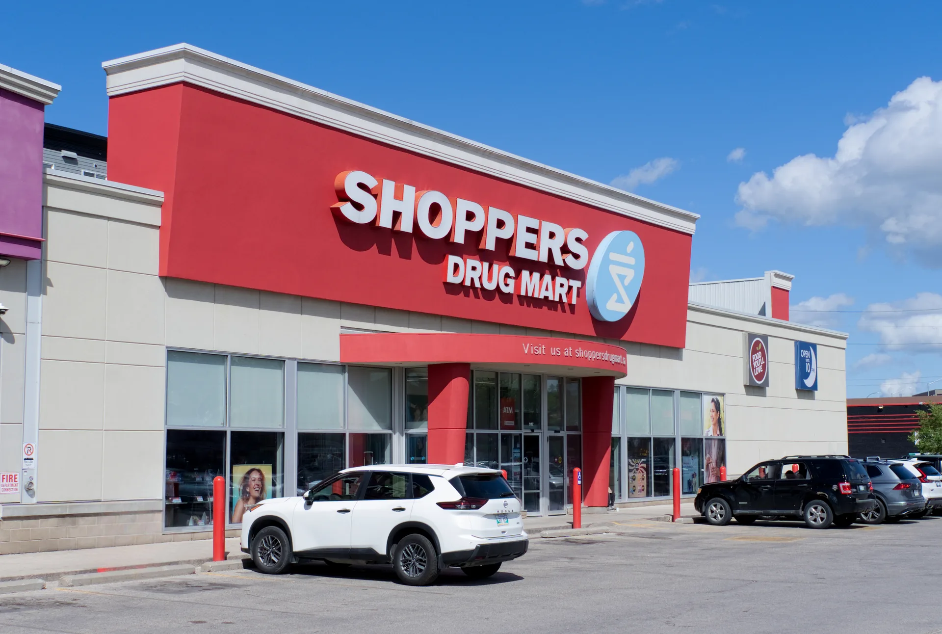 Shoppers Drug Mart storefront in Winnipeg with the red signage bulkhead above the entrance