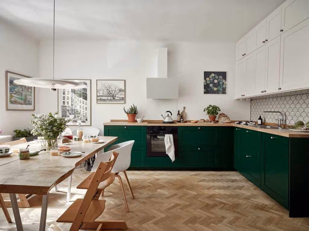 Two-tone cabinetry style, combining forest green lower units with white upper cabinet