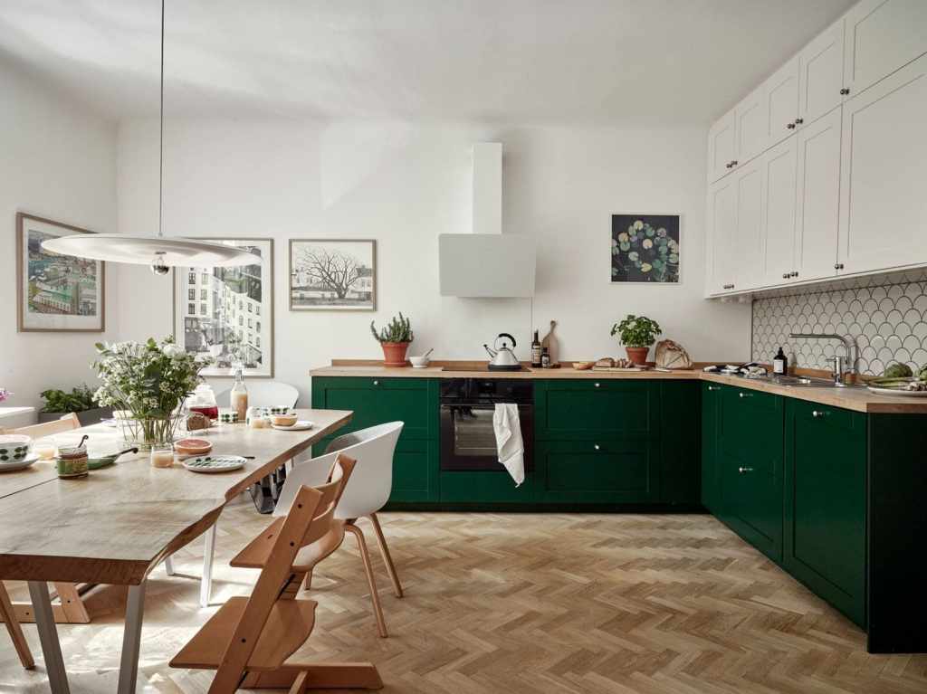 Two-tone cabinetry style, combining forest green lower units with white upper cabinet