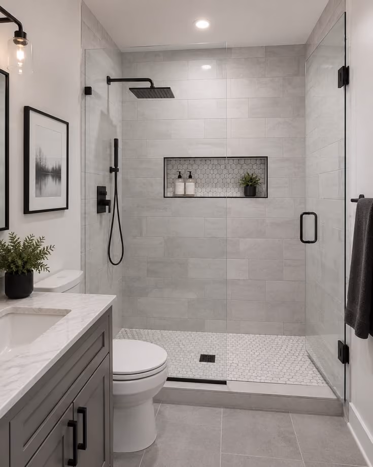 This may contain: a bathroom with a walk in shower next to a toilet
