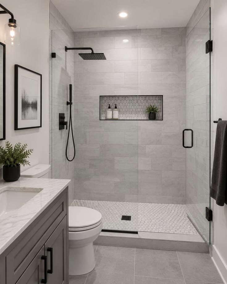 This may contain: a bathroom with a walk in shower next to a toilet