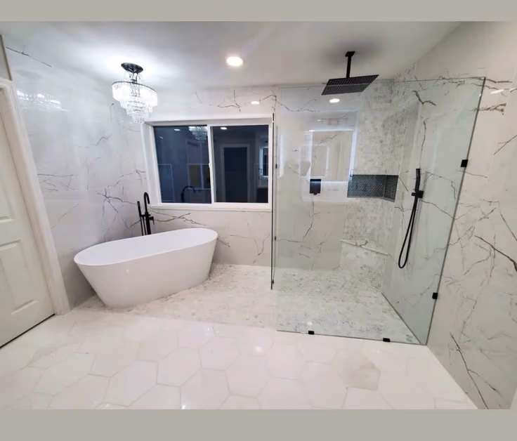 This may contain: a large bathroom with marble floors and white fixtures, including a freestanding bathtub