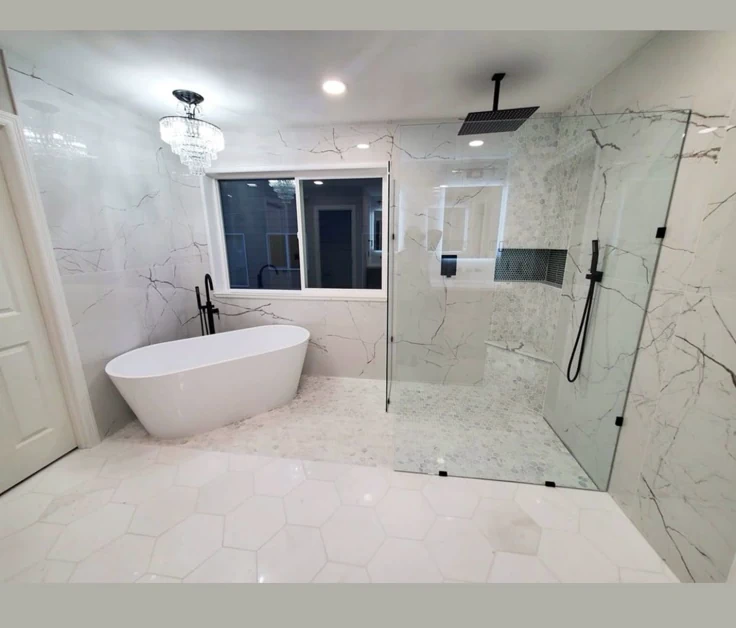 This may contain: a large bathroom with marble floors and white fixtures, including a freestanding bathtub