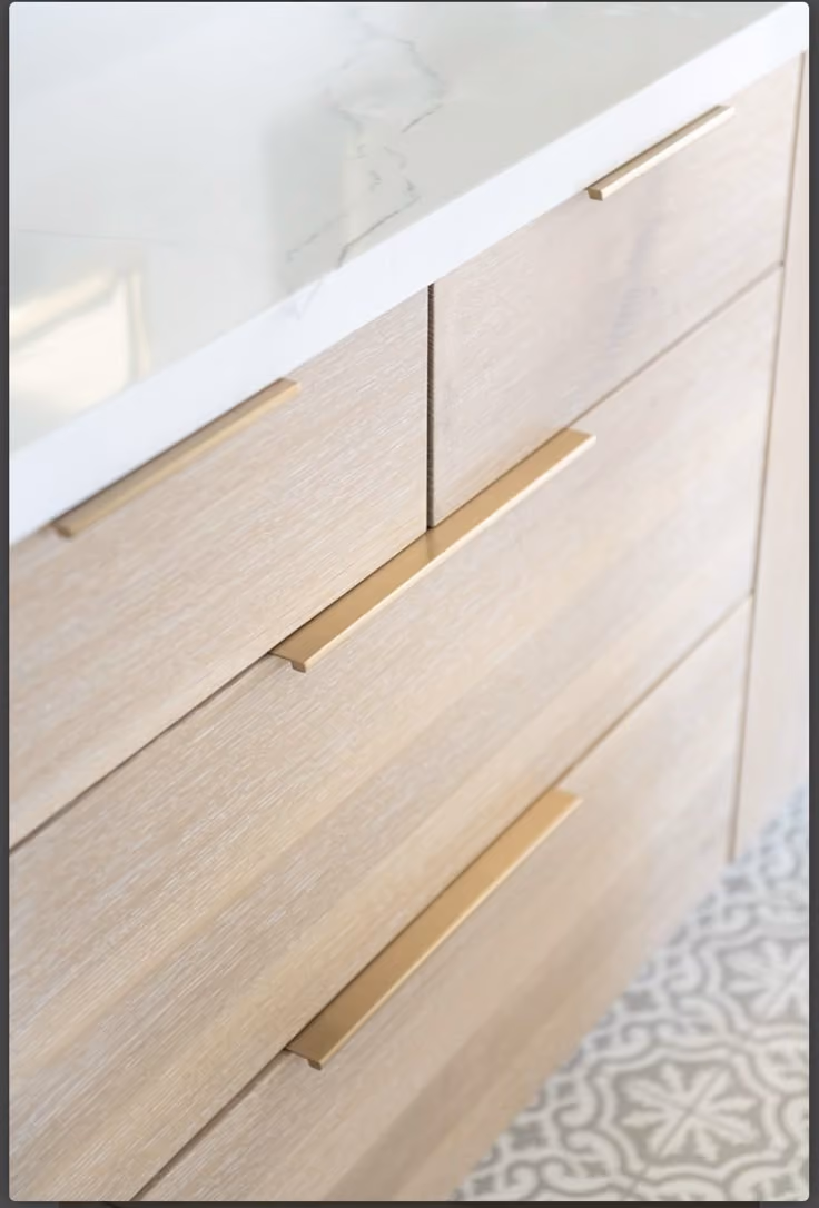 This may contain: a white counter top sitting next to a wooden dresser