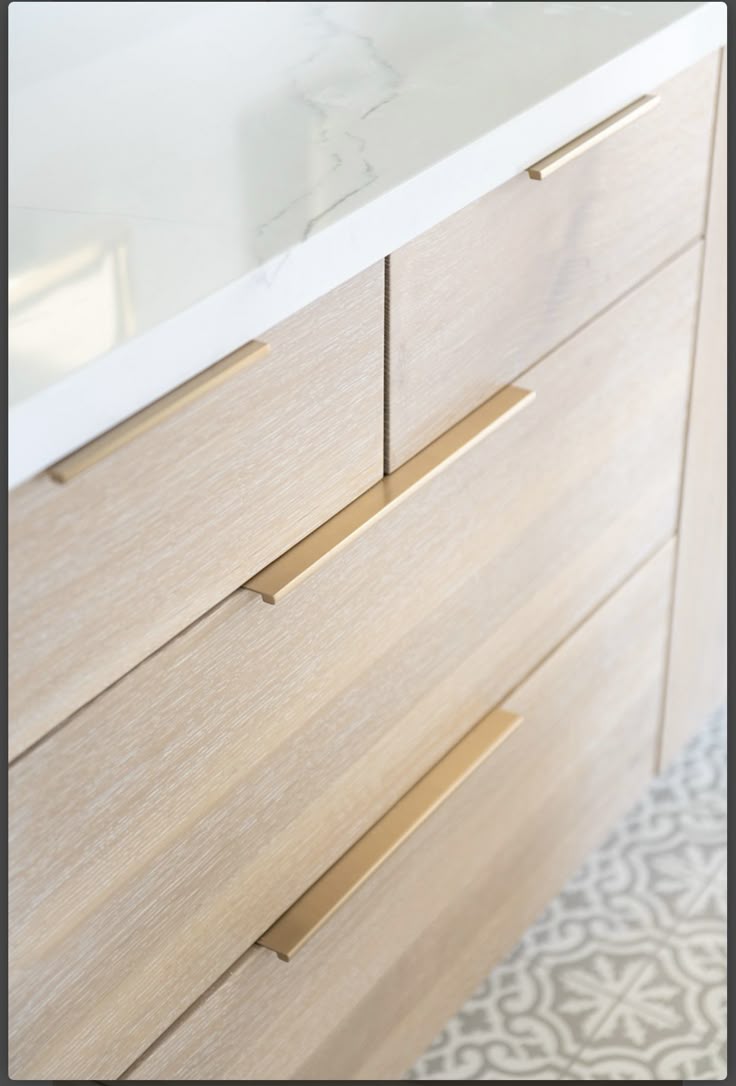 This may contain: a white counter top sitting next to a wooden dresser