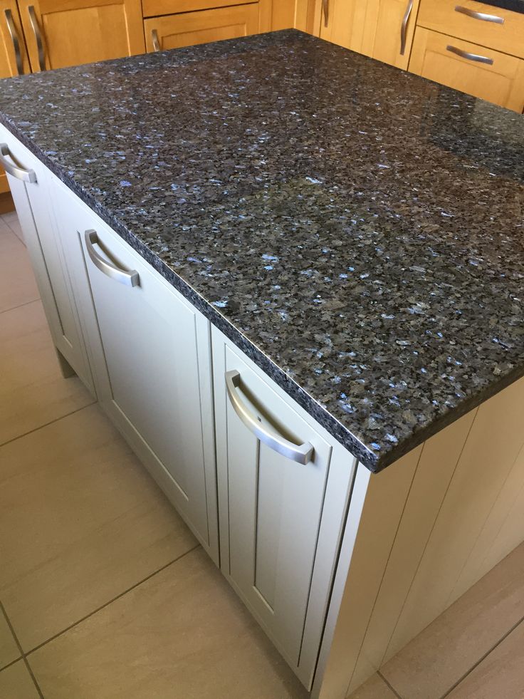 This may contain: an image of a kitchen setting with granite counter tops and cabinets in the backround