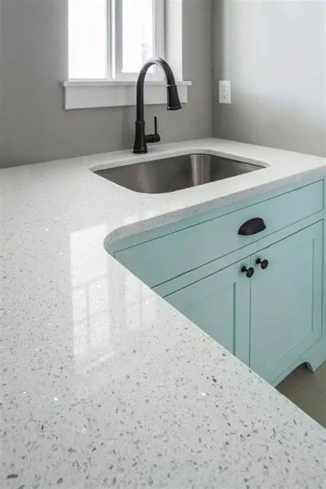 This may contain: a kitchen with white counter tops and blue cabinets
