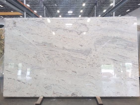 This may contain: a large white marble slab in a warehouse
